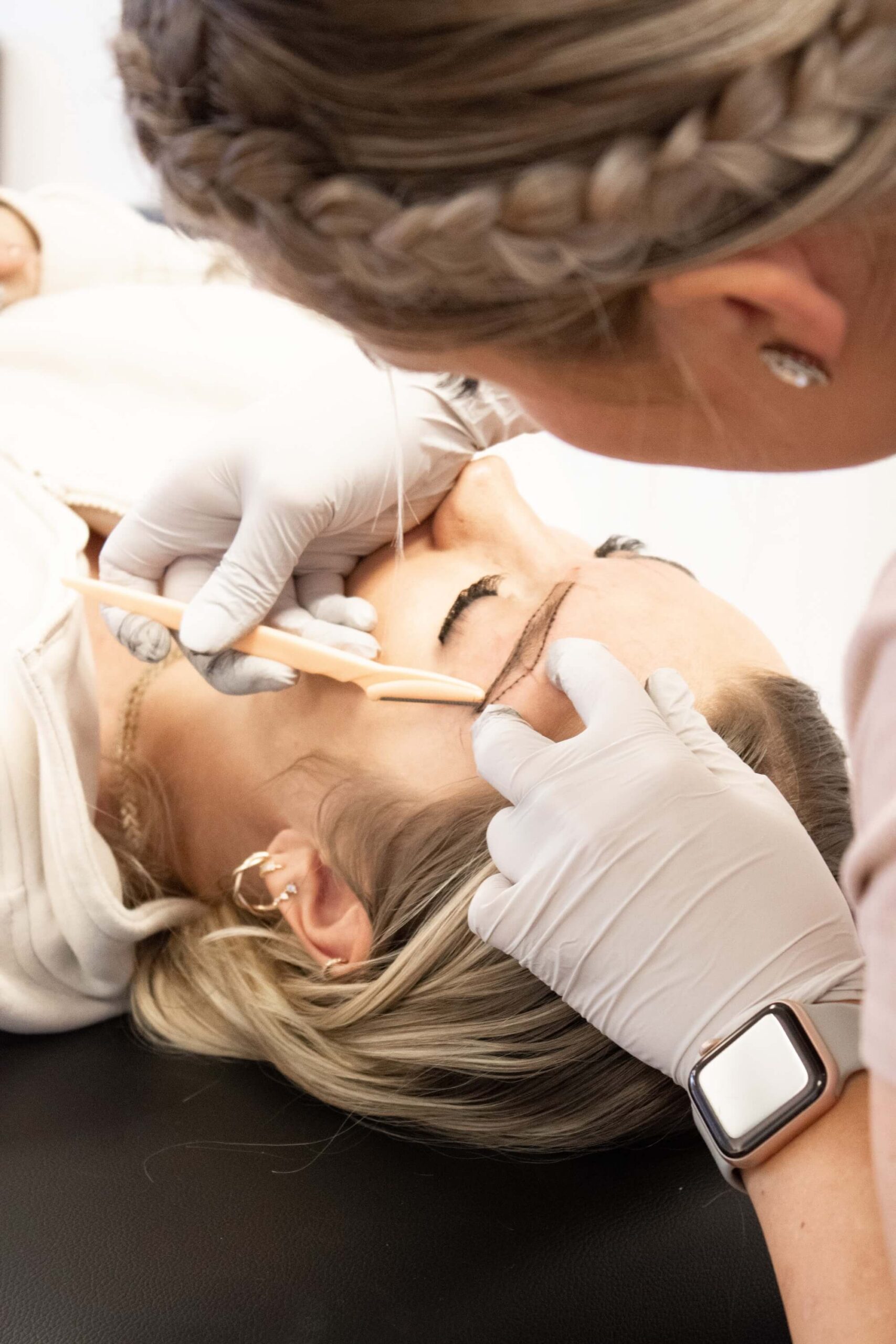 mattie cleaning up eyebrows for microblade treatment in logan UT